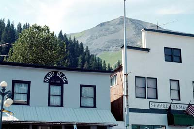 Tops of two buildings back-dropped by a mountain