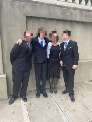 Family standing outside of a church for a funeral.