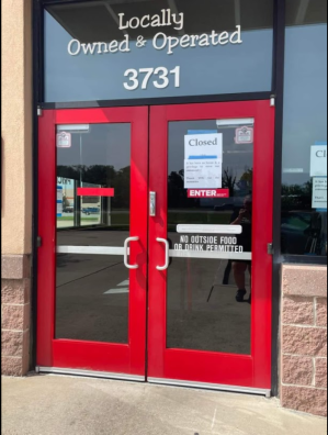 Chuck E. Cheese doors with signs on them saying that they are closed for good!