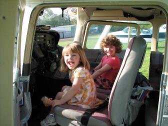 Girls in the Plane ~  Katie and Lucy want to go fly. 