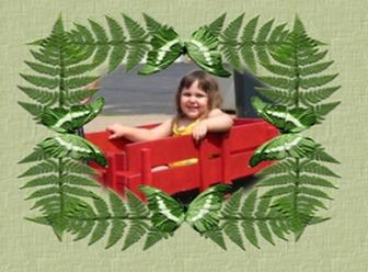 Emma in her new red wagon, age 2-1/2 ~ Emma just loves her wagon and occasionally will allow her little brother to sit in with her for a ride around the apartment complex.