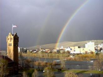 Rainbow's end ~  The rainbow's end is just to the west of the courthouse. It was a full rainbow. The eastern end was by exit 105 of I 90. *Smirk* No gold was found ... or better to say, none was reported. The flag is waving from the old Milwaukee road depot. Taken from my apartment building looking north, November 10, 2008 in Missoula, Montana. 